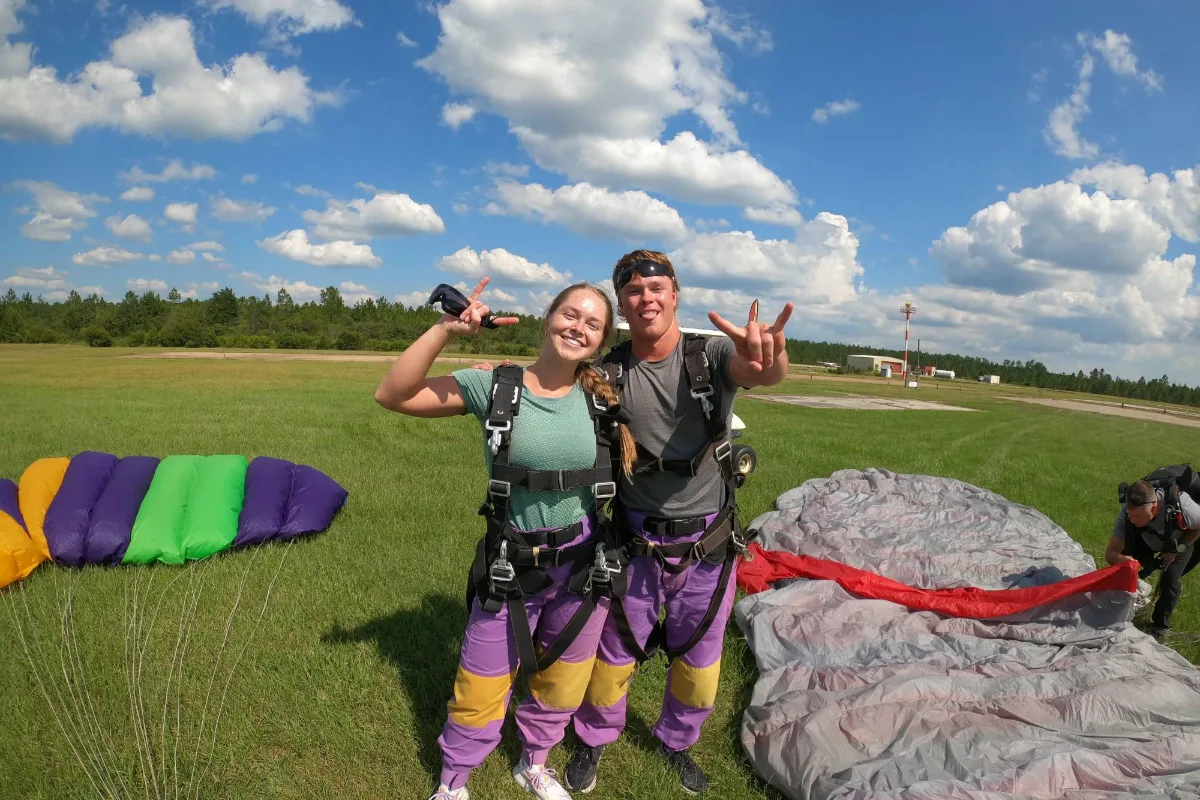 Tandem student and instructor celebrating after landing