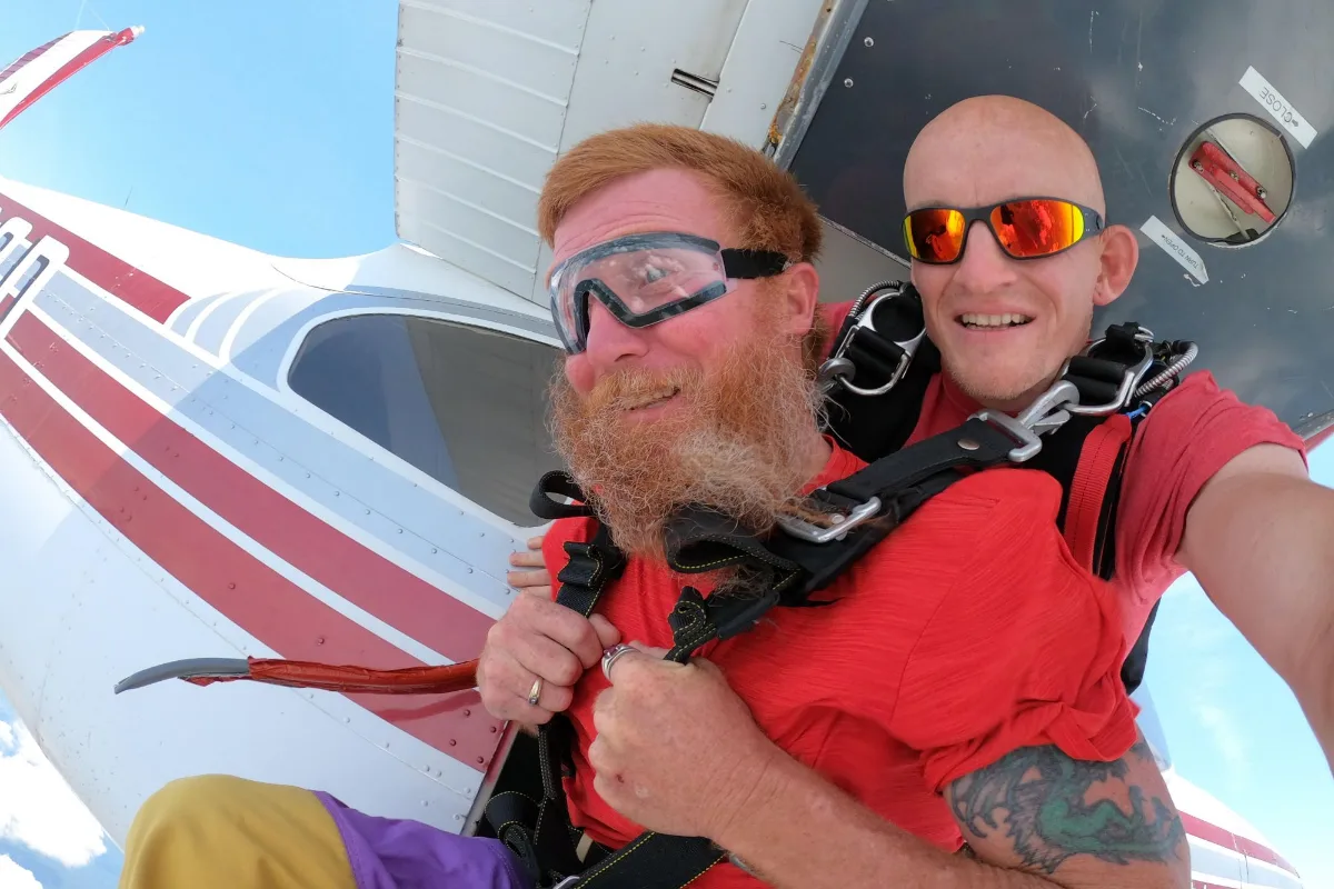 Tandem skydivers at the door of the Gold Coast Skydivers plane